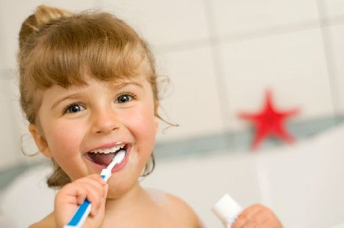 Happy child brushing her teeth after a visit to BrightSmile Dental